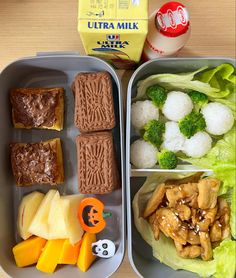 two trays filled with different types of food next to each other on a table