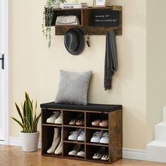 a shoe rack with shoes and hats on it next to a wall mounted coat rack