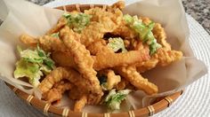 a basket filled with fried food on top of a table