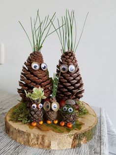 three pine cones with googly eyes on them