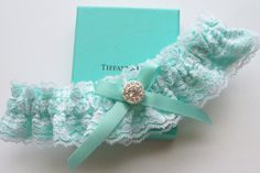 a garter with a brooch on it sitting next to a box