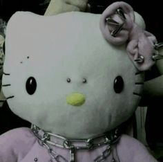 a hello kitty stuffed animal with chains around it's neck