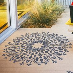 an outdoor area with a rug, chair and potted plant