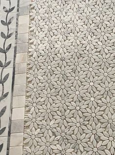 the tile is white and has black leaves on it