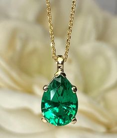 "This pear shape emerald pendant is 10x7mm 2.00 carats set in 14K yellow/white gold. This emerald teardrop pendant necklace is the May birthstone. This makes a great layering or stacking necklace as a Christmas gift, Anniversary, wedding, birthday or bridal wedding jewelry. The pendant pictured is a lab created green emerald #7033 This pendant can be made with many different stone colors Message us for pricing on different color/type stones for emerald earrings click here: https://etsy.me/3Pcg3X Luxury Gold Emerald Necklace With Round Pendant, Emerald And Gold Necklace, Fine Jewelry Emerald Necklace With Pear Gemstone, Pear-shaped Emerald Necklace In Fine Jewelry Style, Fine Jewelry Emerald Teardrop Necklace For Anniversary, Fine Jewelry Teardrop Emerald Necklace For Anniversary, Emerald Pear-shaped Necklace For Anniversary, Fine Jewelry Green Pear-shaped Necklaces, Fine Jewelry Green Pear-shaped Necklace