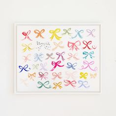 an art piece with many different colored bows on the front and back of it's frame