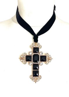 Black cross statement choker from Olivia Divine. Over-sized, black jewelled cross pendant. Set on a black velvet ribbon. Ties at the back, so can be worn as a choker or at a longr5 length. Cross 9 cm x 7 cm approx. Handmade deisgn. Adjustable Cross Jewelry For Party, Black Cross Choker Necklace, Black Cross Choker As Gift, Cross Choker For Party, Elegant Cross Choker As A Gift, Black Cross Choker For Party, Black Cross Pendant Necklaces For Party, Black Cross Pendant Necklace For Party, Vampire Lestat