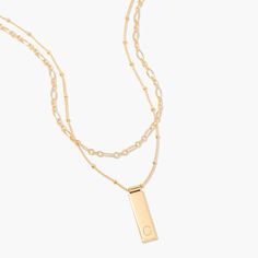 Be fabulous in this 14k gold plated layering necklace set that combines personalized beauty and modern glamour. The rectangle pendant is personalized with your initial and hangs from a satellite chain which is paired with a delicate chain to create an iconic look. Be fabulous day or night with this stunning necklace set. Available in 14k gold plated brass Maisie Pendant: Size: 1" by 1/4"; Length: 18" satellite chain with 2" extender Vivi Necklace: Size: 4mm; Length: 16" chain with 2" extender Lo Elegant Gold Rectangular Initial Necklace, Elegant Yellow Gold Rectangular Initial Necklace, Elegant Personalized Necklace With Rectangular Links, Elegant Personalized Charm Necklaces, Elegant Rectangular Pendant Necklaces For Layering, Elegant Layering Necklace With Rectangular Pendant, Elegant Rectangular Pendant Necklace For Layering, Elegant Personalized Rectangular Chain Necklace, Elegant Personalized Charm Necklaces For Layering