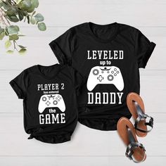 Leveled up Shirt, Dad and Son Matching Shirts, New Dad Shirt, Dad Shirt, Father's Day Shirt, Gift for Dad, Daddy Shirt, Fathers Day Gift, Dad and Kid Matching Clothing WELCOME TO MY STORE! HOW TO ORDER? == Please, choose your favorite color and size from the drop down menu. == Select the quantity that you want. == Click "ADD TO CART". ** You can go back and repeat the same steps to add more product  == Please "Click Proceed to Check Out" Finally, you have completed all the steps, your product wi Matching Graphic Print Tops For Father's Day, Funny Print Cotton Top For Father's Day, Casual Tops With Funny Print For Father's Day, Casual Slogan Shirt For Father's Day, Father's Day Matching Letter Print Shirt, Father's Day Casual Slogan Tops, Father's Day Matching Letter Print Tops, Black Slogan Top For Father's Day, Matching Clothing