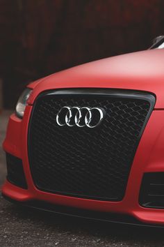 the front end of a red audi car