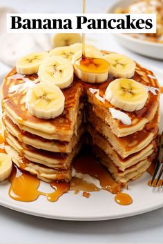 a stack of pancakes topped with bananas and syrup