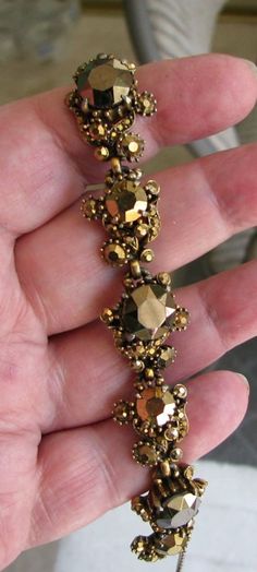 "Hollycraft Copr 1958 bracelet in shades of gold - aurum and bronze. This is in excellent, clean condition. No missing, bad, dull or yellowing stones. No noticeable wear or damage to gold tone frame except some minor wear on back. Measures 7 1/4\" x 3/4\"."