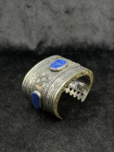 Beautiful Rare Vintage Handicraft Afghani Silver Bangle With Lapis Lazuli Stone From Afghanistan. Unique Bangle For Collection. Shipping Payment Feedback & Return Policy 1 : We ship Monday to Friday Via Airmail Register Insured  With Tracking # takes 2 to 4 Weeks to Destination. 2 : Contact us if you did not receive your item after 4 weeks. 3 : We Accept Payment From Most of the Mainstream Payment Methods. 4 : In Any Inconvenience Case we do Accept Return and full Refund. 5 : We Ship worldwide v Adjustable Artisan Blue Bangle, Artisan Blue Bangle Cuff Bracelet, Blue Bracelet With Intricate Design As A Gift, Artisan Blue Cuff Bangle Bracelet, Blue Ceremonial Bracelet Jewelry, Ceremonial Blue Bracelet Jewelry, Traditional One-of-a-kind Bracelet Jewelry, Blue Ceremonial Bangle Jewelry, Artisan Blue Bangle Bracelet