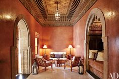 an ornately decorated living room with arched doorways and lamps on either side of the couch