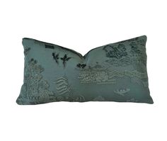 a green pillow with embroidered designs on it