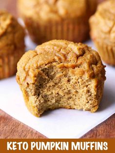 a muffin cut in half sitting on top of a white paper with the words keto pumpkin muffins