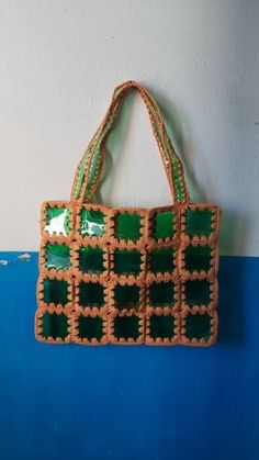 a green and brown bag hanging on the wall