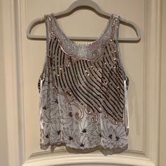 This Is An Absolutely Beautiful Beaded Sleeveless Top. Made Of Semi-Sheer Cream Colored 100% Silk Adorned With Bronze Embroidery, Tiny Silver Beads And Shiny Copper And Matte Gold Sequins. Back Zipper (Full Length) This Top Is A Real Stunner!! Brand New With Tags. Purchased At A Boutique, Never Worn. Size Small Spring Beaded Fitted Tank Top, Chic Embellished Tank Top For Party, Spring Beaded Tank Top For Party, Embellished Sleeveless Tank Top For Evening, Embellished Sleeveless Evening Tank Top, Spring Party Beaded Tank Top, Sleeveless Party Tank Top With Beaded Straps, Chic Sleeveless Top With Beaded Straps, Fitted Beaded Sleeveless Tank Top