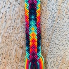 a multicolored beaded bracelet with tassels