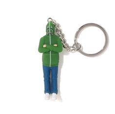 a keychain with a person wearing a green jacket and blue jeans on it