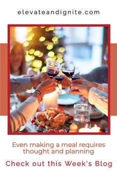 two people toasting wine glasses over a dinner table with food and candles on it