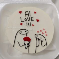 a white plate topped with a cake covered in frosting and writing on the side