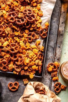 a tray filled with cheetos next to a cup of coffee