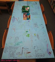 a long table covered in writing and pictures