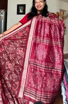 ✨This 8 ply master piece is woven ikkat (bandha) pure silk saree in maroon color..The saree depicts people celebrating festival with dance, Mrudang,trees and other nature inspired motifs in the body. The Anchal is very gorgeous and have various Jhoti (Rangoli) designs that are used in Odisha. Both side of the saree have rudraksh border.  ✨ Comes with fall pico stitched and an unstitched blouse piece. 👉Sambalpuri Sarees of Odisha are known as the finest handloom.  👉The sarees reflect an original style of craft known as Baandha (Ikat) Traditionally. 👉These Baandhas are hand weaved with images of flora or fauna or with geometrical patterns or temple inspired motifs.  💫Adorn elegance in this gorgeous Sambalpuri Ikat pure silk saree from us.  Note- Slight variation in color possible due to Red Tussar Silk Pre-draped Saree With Motifs, Pre-draped Saree With Traditional Patterns For Navratri, Raw Silk Saree With Motifs For Puja, Tussar Silk Saree With Motifs For Navratri, Bollywood Style Saree With Traditional Patterns In Raw Silk, Red Cotton Silk Saree With Traditional Patterns, Bollywood Style Raw Silk Saree With Traditional Patterns, Katan Silk Pre-draped Saree With Motifs For Navratri, Bollywood Style Saree In Raw Silk With Traditional Patterns