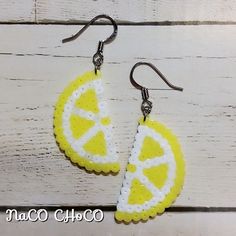 the earrings are made out of plastic and have lemon slices on them