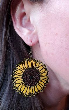 Wooden sunflower earrings handpainted and sealed to preserve color. Antique brass ear wire. Length of earring: 2 inches Width of earring: 2 inches Yellow Sunflower Dangle Earrings, Yellow Sunflower Design Dangle Earrings, Hand Painted Yellow Earrings For Summer, Yellow Flower Shaped Jewelry With Sunflower Print, Yellow Flower-shaped Jewelry With Sunflower Print, Yellow Sunflower Design Earrings For Summer, Yellow Sunflower Design Flower Earrings, Wooden Sunflower, Wood Sunflower