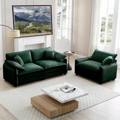 a living room with two green couches and a coffee table