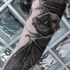 a person with a bat tattoo on their arm