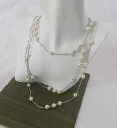 Every woman needs pearls in their collection and this designer necklace, at 60" length is multi-functional. Made by Premier Designs Jewelry it features silver plated chain and highly polished faux pearls with a large lobster clasp. This piece is New Old Stock, has never been worn, from when I was selling this brand and is in excellent condition. If you have questions, contact me and I'll be happy to assist you. Thank you for stopping by and have a wonderful shopping day! Elegant Silver Chain Layered Necklace, Silver Double Strand Pearl Necklace For Anniversary, Formal Pearl White Chain Necklace, Formal Pearl Chain Necklace With Beaded Chain, Formal Pearl Beaded Chain Necklace, Silver Multi-strand Pearl Chain Necklace, Silver Multi-strand Layered Necklace With Pearl Chain, Party Silver Long Necklace With Pearl Chain, Elegant Pearl Chain Necklace With Silver Chain