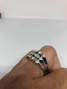 Rich and very bright Peridot green ring white white sapphire Sterling silver with rhodium finish Size 8, can be sized by my jeweler. His service charge is $10-$20 All rings are shipped in a nice gift box. Check out our over a THOUSAND great reviews Engraving is $4 per letter and is not always perfect depending on the piece. It can take a few days if the jeweler is busy. This is payable to Paypal Judithsltd@gmail.com Green Diamond Cut Diamond Ring, Green Multi-stone Sapphire Diamond Ring, Green Emerald Ring With Diamond Accents In Sterling Silver, Green Multi-stone Diamond Ring, Green Sterling Silver Round Cut Diamond Ring, Green Diamond Ring With Sterling Silver Round Cut, Green Rings With Diamond Accents, Green Diamond Rings With Diamond Accents, Green Diamond Ring With Round Cut In Sterling Silver