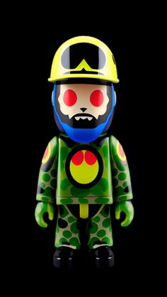 a toy with a helmet and goggles on it's head, standing against a black background