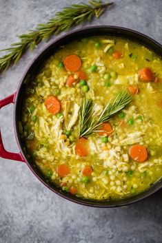 a pot filled with soup and vegetables on top of a table