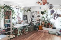 a living room filled with furniture and lots of plants