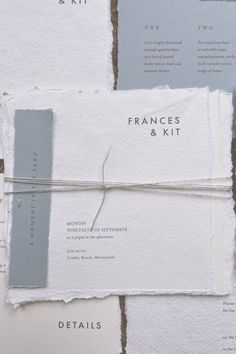 A wedding invitation featuring soft white papers with torn edge and modern typography. A hand sewn strip of air blue paperstock sits on one side of the invitation with the words 'A moment in the sand', all bound together with grey thread. Beachy Wedding Invites, Modern Coastal Wedding Invitations, Wave Wedding Invitations, France Kit, Coastal Invitation Wedding, Coastal Wedding Invitations, Beach Color Palettes, Wedding Finger, Creative Wedding Invitations