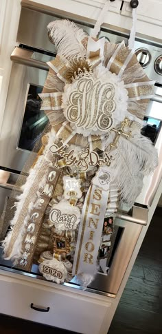 a white and gold decoration hanging from the side of an oven