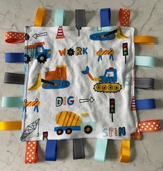 a baby's bib with construction vehicles on it