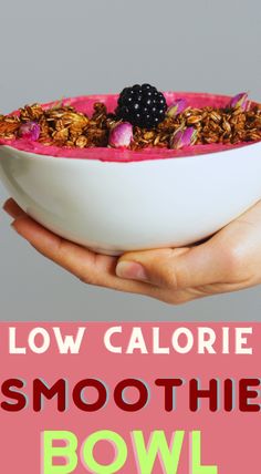 a person holding a bowl filled with granola and blackberries in front of the words low calorie smoothie bowl