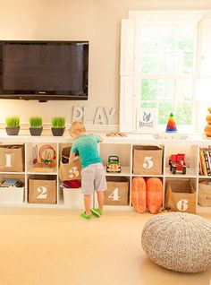 a little boy playing with toys in his playroom