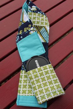 a pair of blue and green cloths sitting on top of a wooden table next to a red bench