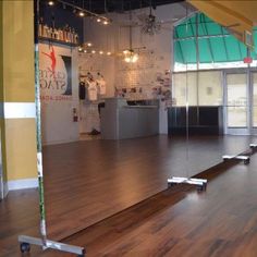 an empty dance studio with hard wood floors