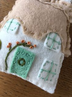 a close up of a piece of fabric on a table with buttons and needles attached to it