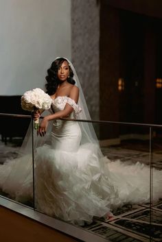 a woman in a wedding dress holding a bouquet