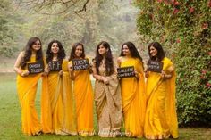 a group of women in yellow dresses holding signs