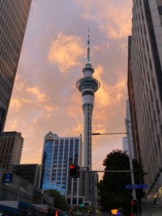 the sky is pink and blue with some clouds in the background, as well as tall buildings