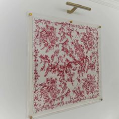 a red and white painting hanging on the wall